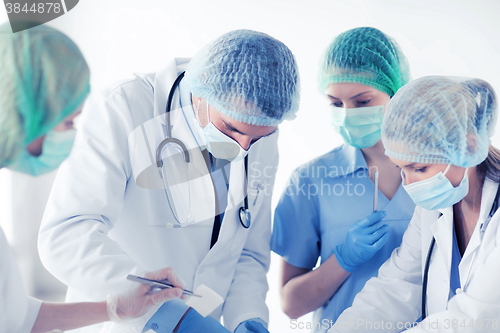 Image of young group of doctors doing operation