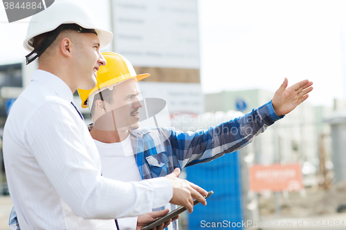 Image of builder and architect with tablet pc outdoors