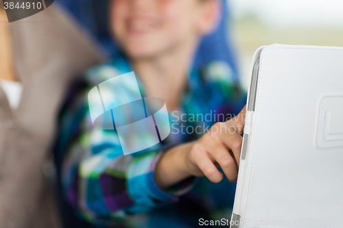 Image of close up of boy with tablet pc in travel bus