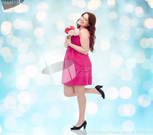 Image of happy young plus size woman with flower bunch