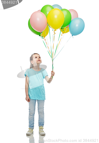 Image of girl looking up with bunch of helium balloons