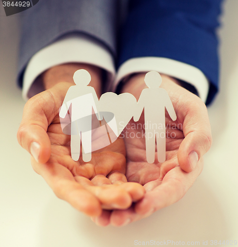 Image of close up of happy male gay couple with love symbol