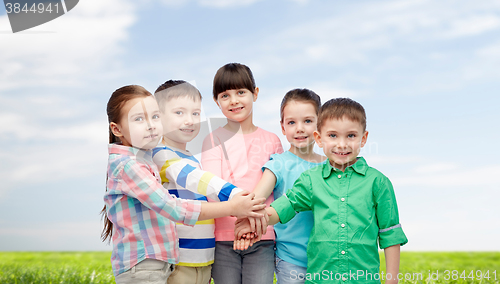 Image of happy little children with hands on top