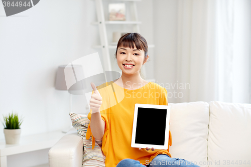 Image of happy asian woman with tablet pc and thumbs up