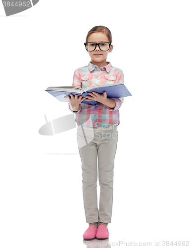 Image of happy little girl in eyeglasses reading book