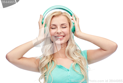 Image of happy young woman or teenage girl with headphones