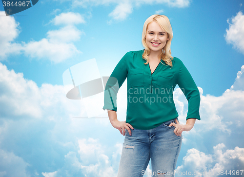 Image of smiling young woman in shirt and jeans