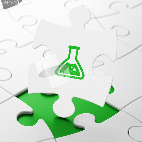 Image of Science concept: Flask on puzzle background