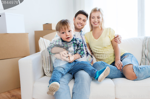 Image of happy family with boxes moving to new home