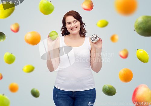 Image of happy plus size woman choosing apple or cookie