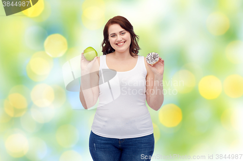 Image of happy plus size woman choosing apple or cookie