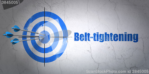 Image of Finance concept: target and Belt-tightening on wall background