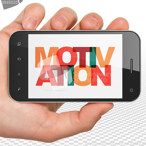 Image of Business concept: Hand Holding Smartphone with Motivation on  display