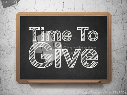 Image of Time concept: Time To Give on chalkboard background