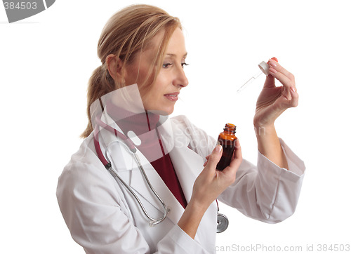 Image of Doctor naturapath with eyedropper and  bottle