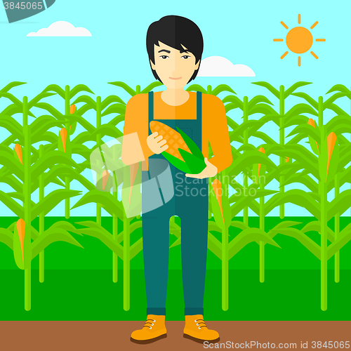 Image of Farmer holding corn.