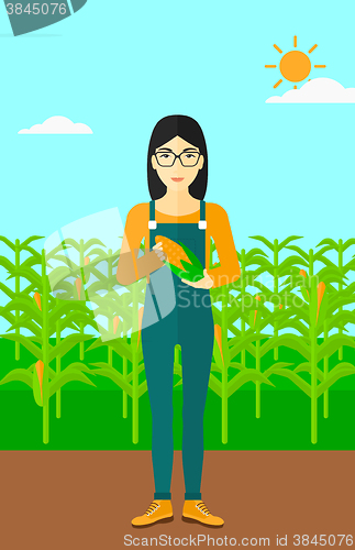 Image of Farmer holding corn.