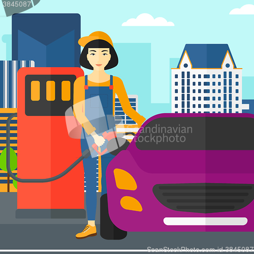 Image of Woman filling up fuel into car.