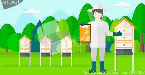 Image of Bee-keeper at apiary.