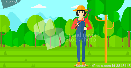 Image of Farmer with pruner in garden.