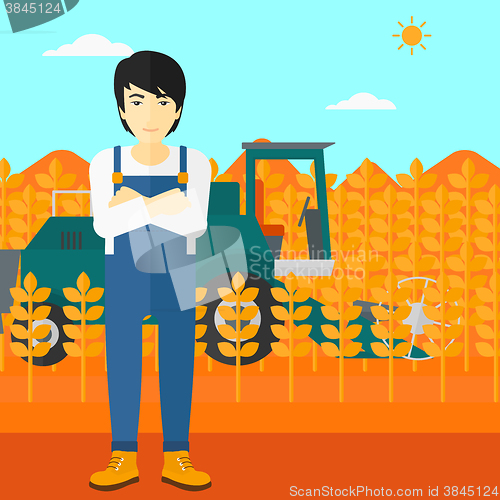 Image of Man standing with combine on background.