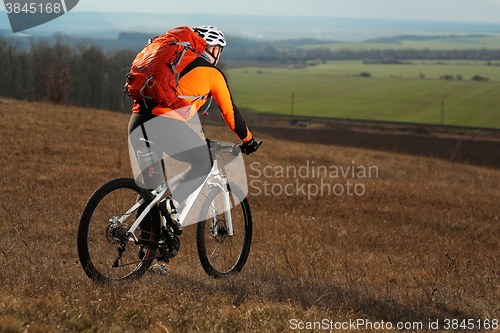 Image of Man cyclist with backpack riding the bicycle