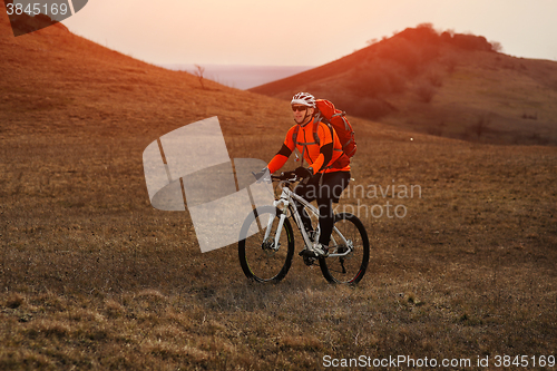 Image of Man cyclist with backpack riding the bicycle