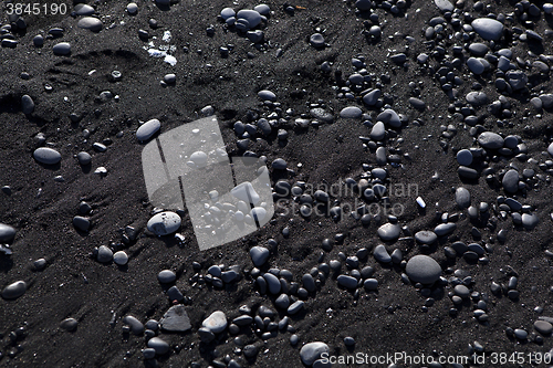 Image of Stone structure at a black sand beach