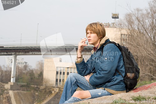 Image of The sitting guy with a cigarette outdoor 1