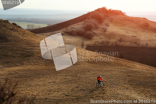 Image of Man cyclist with backpack riding the bicycle