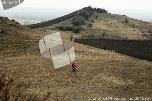 Image of Man cyclist with backpack riding the bicycle