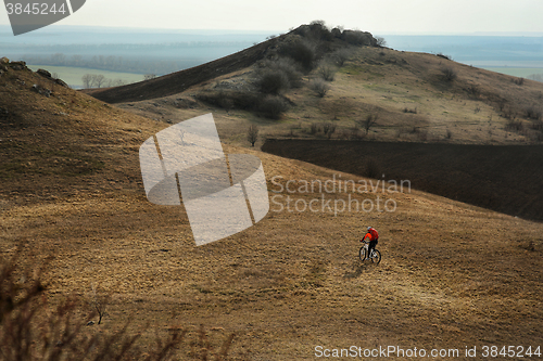 Image of Man cyclist with backpack riding the bicycle