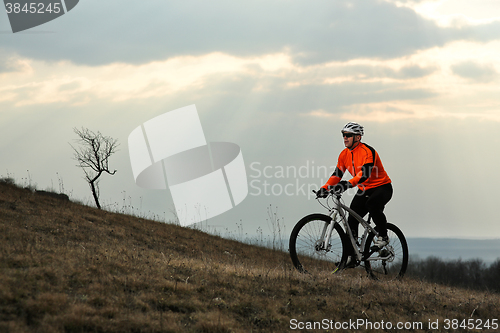 Image of Man cyclist with backpack riding the bicycle