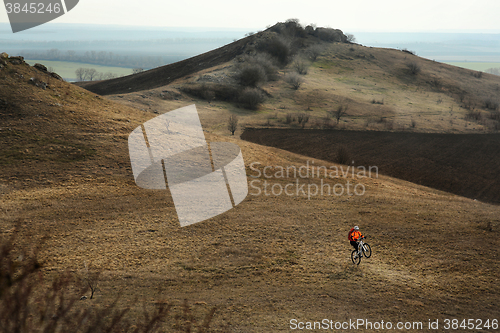 Image of Man cyclist with backpack riding the bicycle