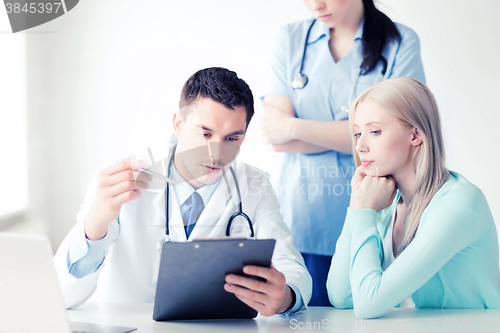 Image of doctor and nurse with patient in hospital