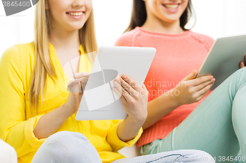 Image of close up of young women with tablet pc at home