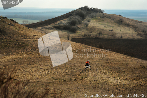 Image of Man cyclist with backpack riding the bicycle