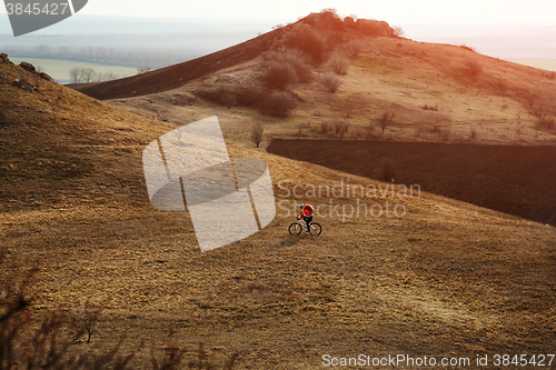 Image of Man cyclist with backpack riding the bicycle