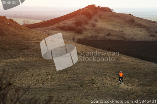 Image of Man cyclist with backpack riding the bicycle