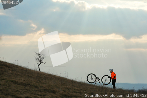 Image of Man cyclist with backpack riding the bicycle