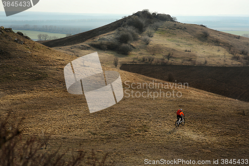 Image of Man cyclist with backpack riding the bicycle