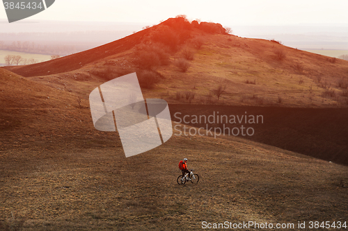 Image of Man cyclist with backpack riding the bicycle