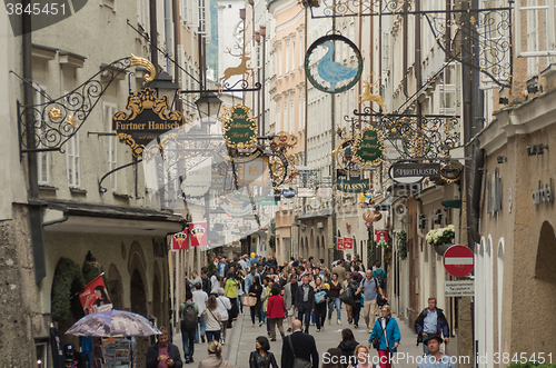 Image of The street full of shops and antiques signs in Salzburg