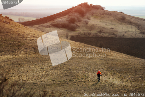 Image of Man cyclist with backpack riding the bicycle