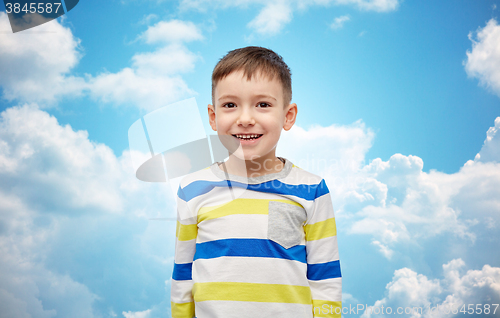 Image of happy smiling little boy over blue sky and clouds