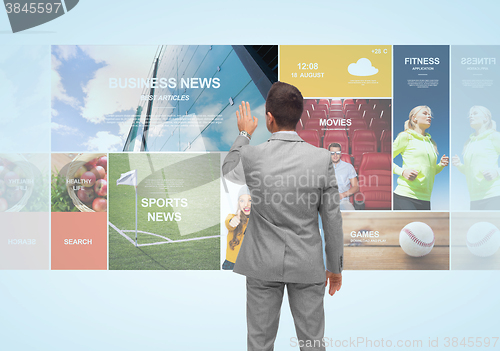Image of businessman with virtual projection of news pages