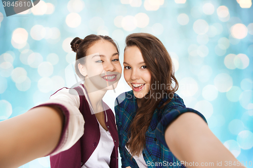 Image of happy smiling pretty teenage girls taking selfie