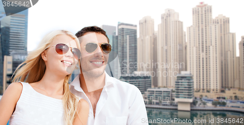 Image of happy couple in shades over dubai city background