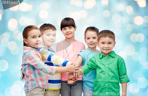 Image of happy little children with hands on top