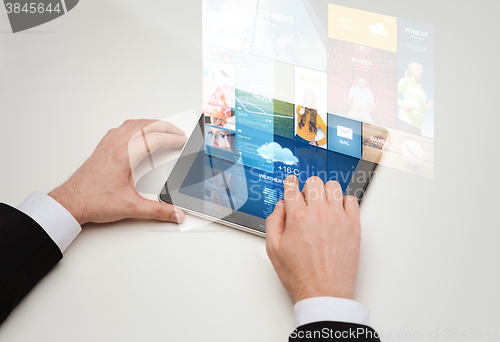 Image of close up of man hands with web pages on tablet pc